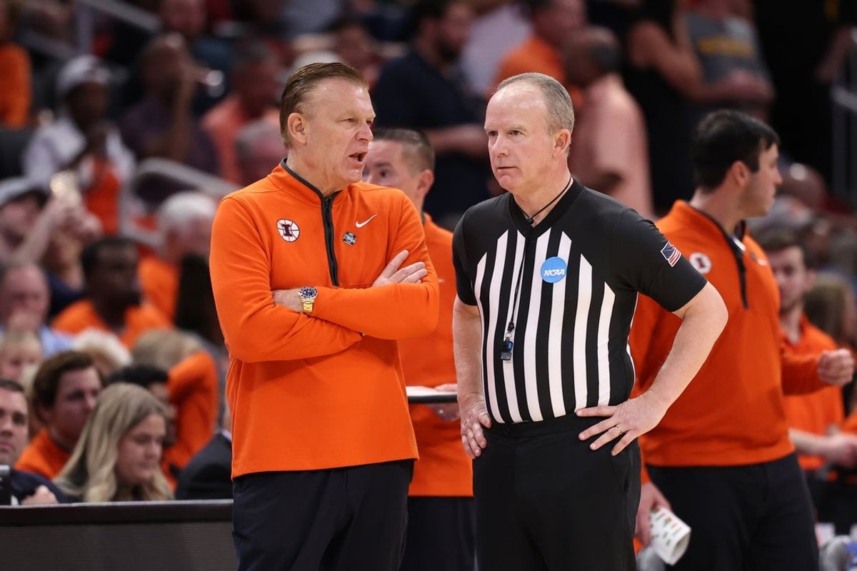 Mar 28, 2026; Houston, TX, USA; Illinois Fighting Illini head coach Brad Underwood talks with an official in the first half against the Iowa Hawkeyes during an Elite Eight game of the South Regional of the men's 2026 NCAA Tournament at Toyota Center. Mandatory Credit: Troy Taormina-Imagn Images