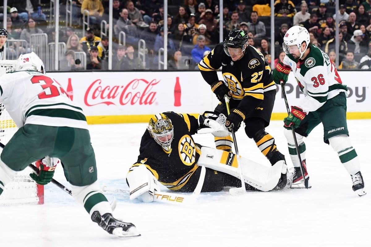 Mar 28, 2026; Boston, Massachusetts, USA; Boston Bruins goaltender Jeremy Swayman (1) tries to gather the puck while Minnesota Wild right wing Mats Zuccarello (36) and defenseman Hampus Lindholm (27) look on during the second period at TD Garden. Mandatory Credit: Bob DeChiara-Imagn Images