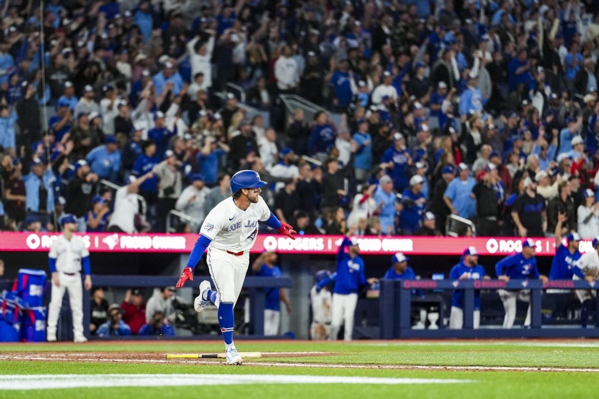 Mar 28, 2026; Toronto, Ontario, CAN;  Toronto Blue Jays third baseman Ernie Clement (22) hits a walk off single against the Athletics during the eleventh inning at Rogers Centre. Mandatory Credit: Kevin Sousa-Imagn Images