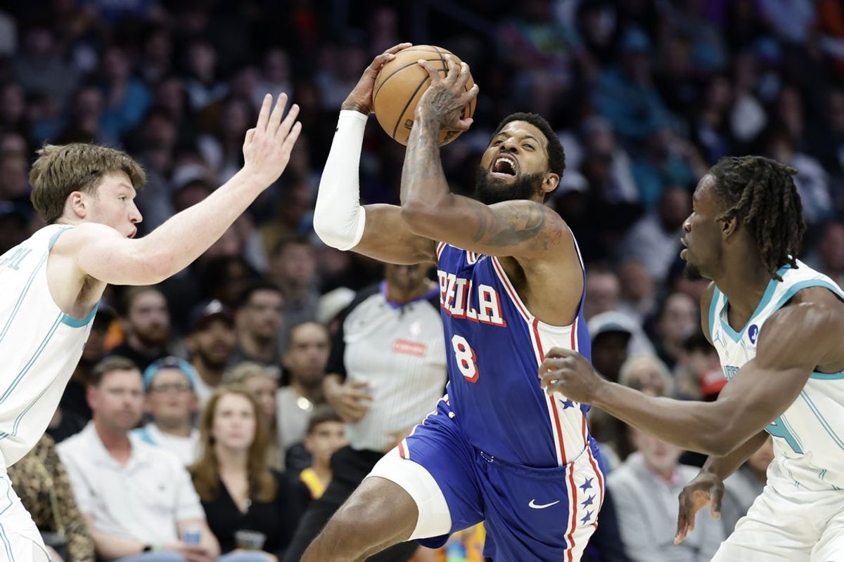 Mar 28, 2026; Charlotte, North Carolina, USA; Philadelphia 76ers forward Paul George (8) tries to drive between Charlotte Hornets guard/forward Kon Knueppel (left) and guard Sion James (right) during the second quarter at Spectrum Center. Mandatory Credit: Brian Westerholt-Imagn Images