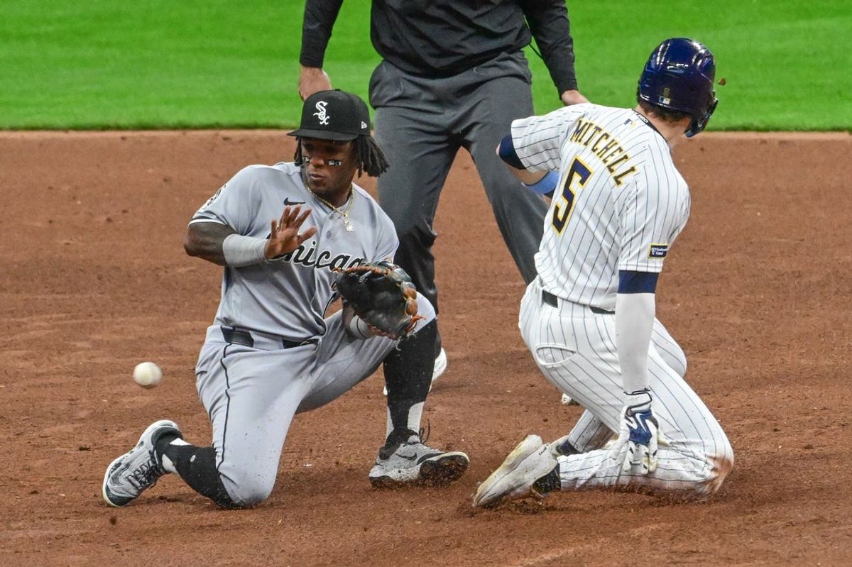 Mar 28, 2026; Milwaukee, Wisconsin, USA; Milwaukee Brewers center fielder Garrett Mitchell (5) steals second base as Chicago White Sox shortstop Luisangel Acuna (0) takes the throw in the first inning at American Family Field. Mandatory Credit: Benny Sieu-Imagn Images