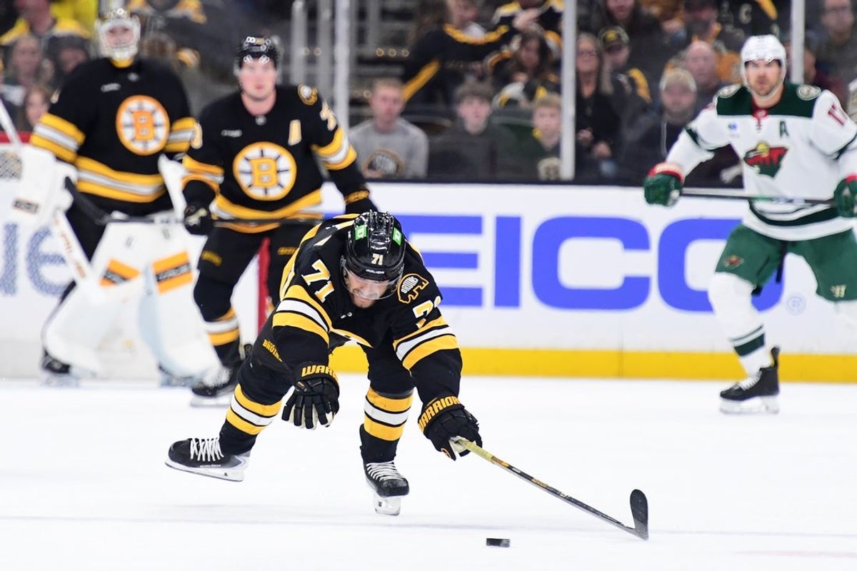 Mar 28, 2026; Boston, Massachusetts, USA; Boston Bruins left wing Viktor Arvidsson (71) riches for the puck during the third period against the Minnesota Wild at TD Garden. Mandatory Credit: Bob DeChiara-Imagn Images