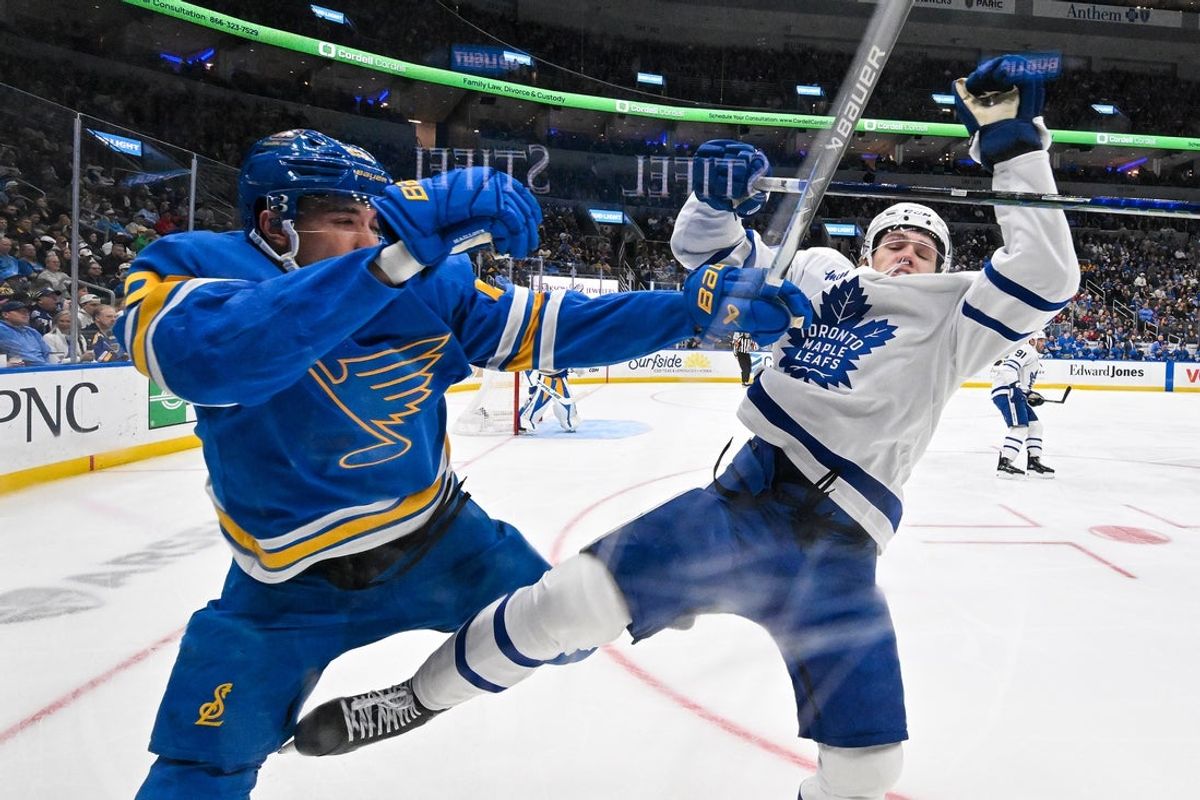 Mar 28, 2026; St. Louis, Missouri, USA; Toronto Maple Leafs right wing Easton Cowan (53) checks St. Louis Blues defenseman Logan Mailloux (23) during the first period at Enterprise Center. Mandatory Credit: Jeff Curry-Imagn Images