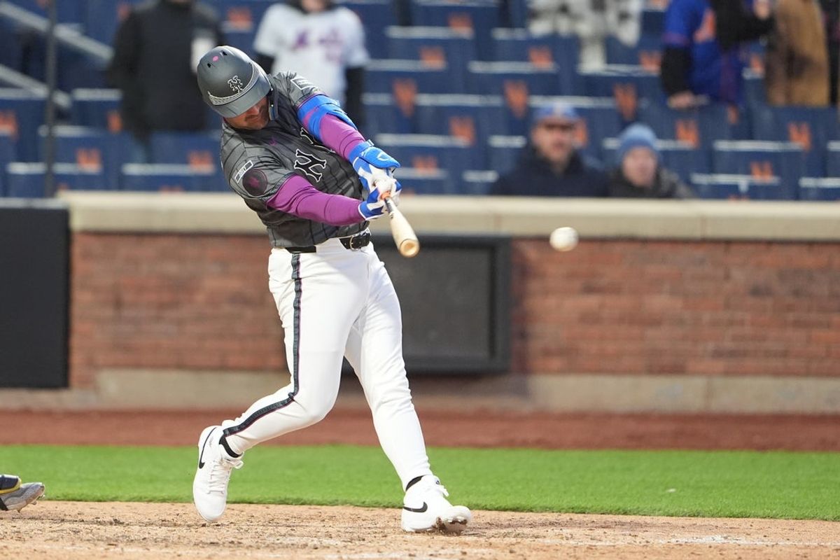 Mar 28, 2026; New York City, New York, USA; New York Mets catcher Luis Torrens (13) hits an RBI single against the Pittsburgh Pirates during the tenth inning at Citi Field. Mandatory Credit: Gregory Fisher-Imagn Images