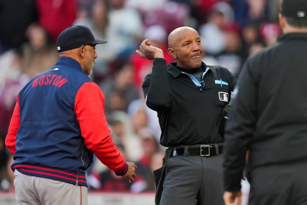 Mar 28, 2026; Cincinnati, Ohio, USA;  MLB umpire CB Bucknor (54) ejects Boston Red Sox manager Alex Cora (13) during the game against the Cincinnati Reds in the eighth inning at Great American Ball Park. Mandatory Credit: Aaron Doster-Imagn Images