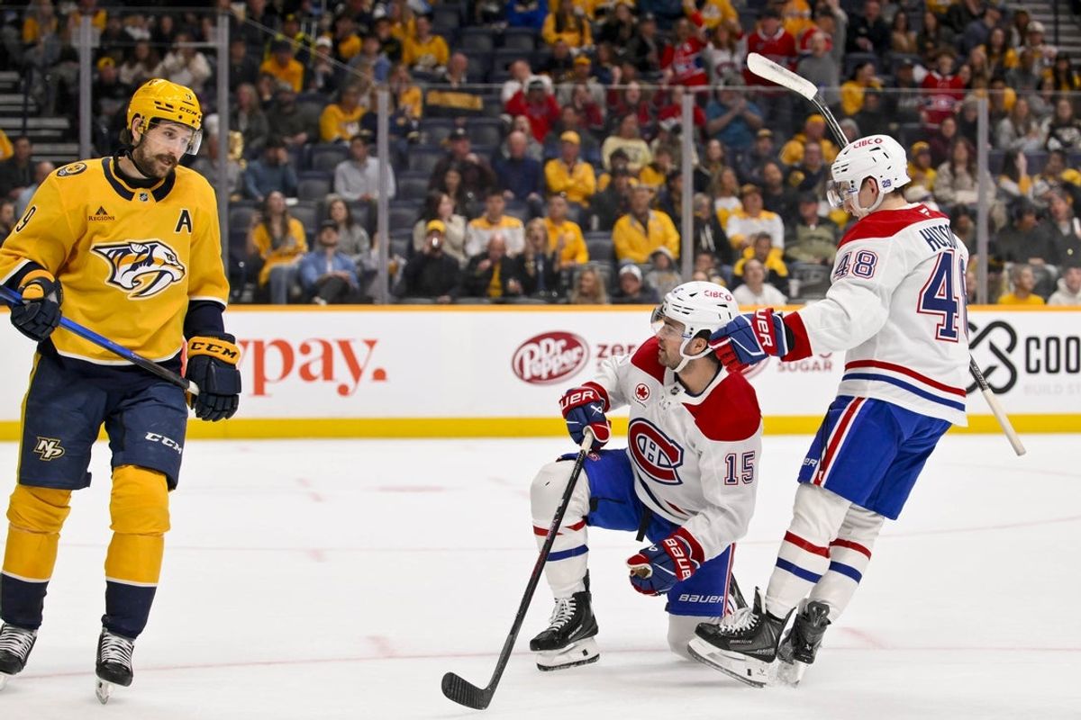 Mar 28, 2026; Nashville, Tennessee, USA;  Montreal Canadiens defenseman Alexandre Carrier (45) celebrates the goal of center Alex Newhook (15) as Nashville Predators left wing Filip Forsberg (9) skates by during the second period Gat Bridgestone Arena. Mandatory Credit: Steve Roberts-Imagn Images