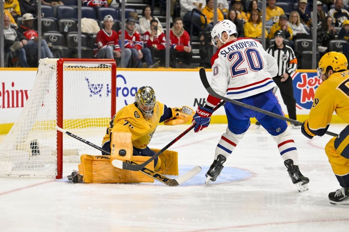 Mar 28, 2026; Nashville, Tennessee, USA;  Nashville Predators goaltender Juuse Saros (74) blocks the shot of Montreal Canadiens left wing Juraj Slafkovský (20) during the second period Gat Bridgestone Arena. Mandatory Credit: Steve Roberts-Imagn Images