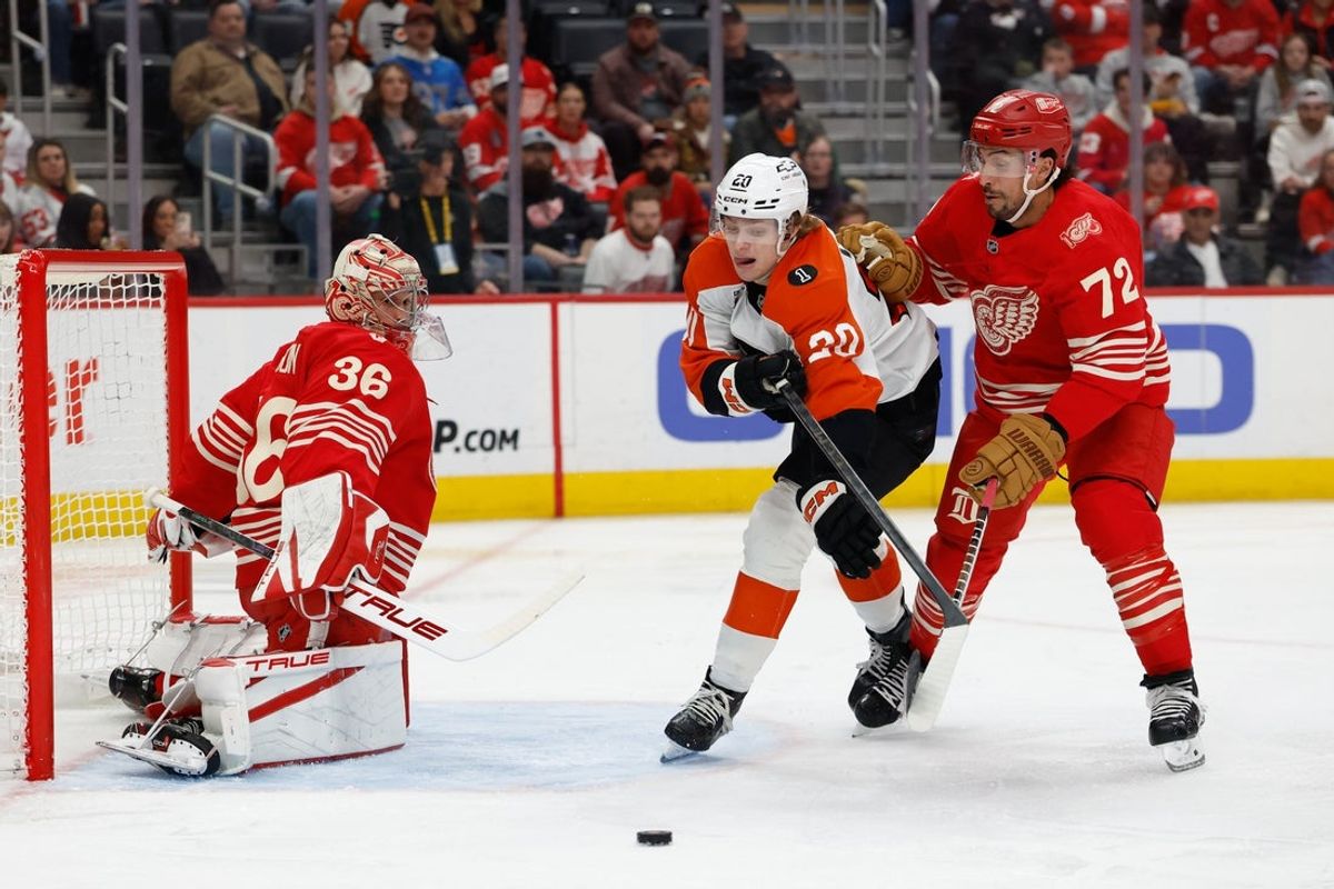 Mar 28, 2026; Detroit, Michigan, USA;  Philadelphia Flyers left wing Alex Bump (20) skates with the puck defended by Detroit Red Wings defenseman Justin Faulk (72) in the first period at Little Caesars Arena. Mandatory Credit: Rick Osentoski-Imagn Images