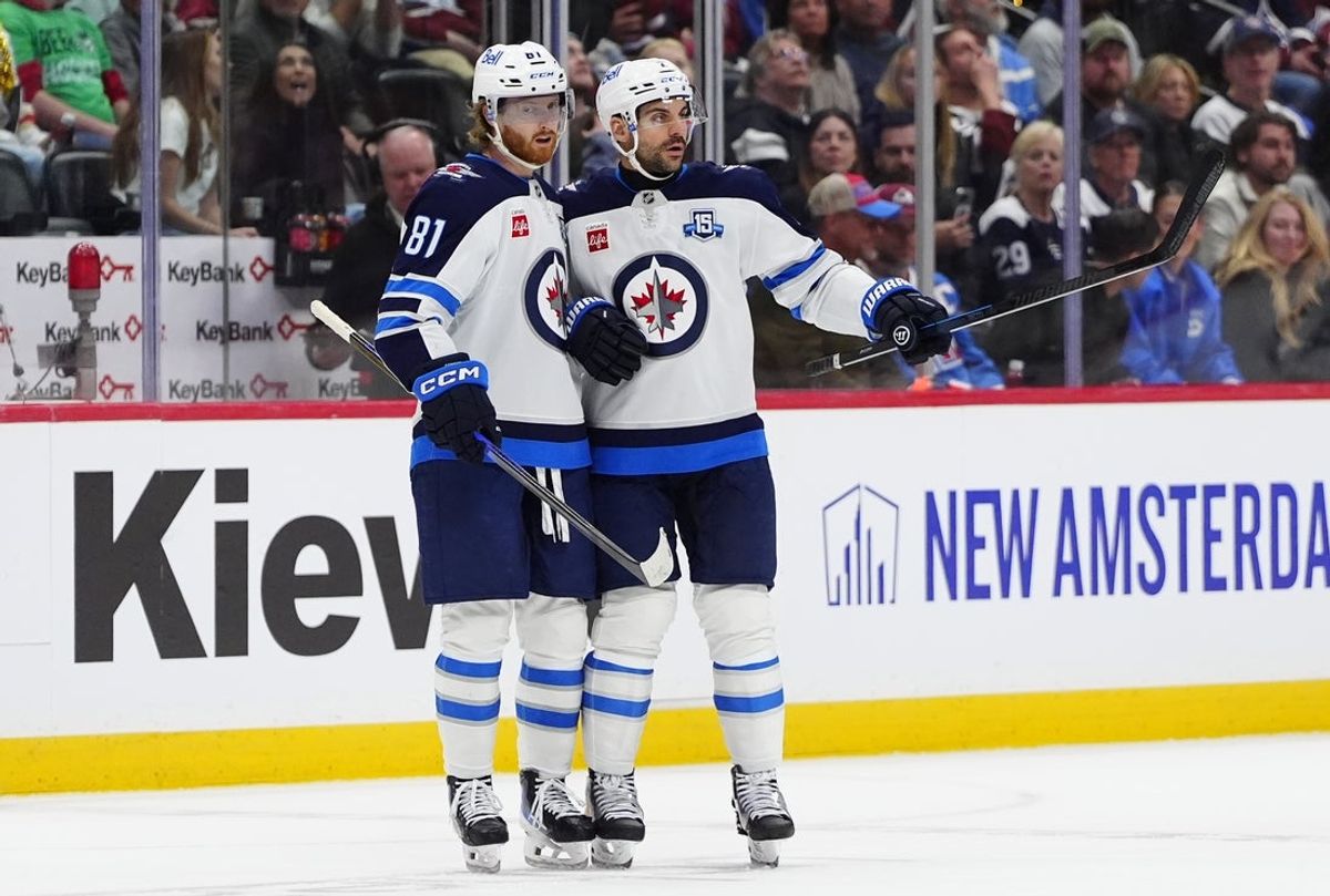 Mar 28, 2026; Denver, Colorado, USA; Winnipeg Jets left wing Kyle Connor (81) celebrates his empty net goal defenseman Dylan DeMelo (2) in the third period against the Colorado Avalanche at Ball Arena. Mandatory Credit: Ron Chenoy-Imagn Images