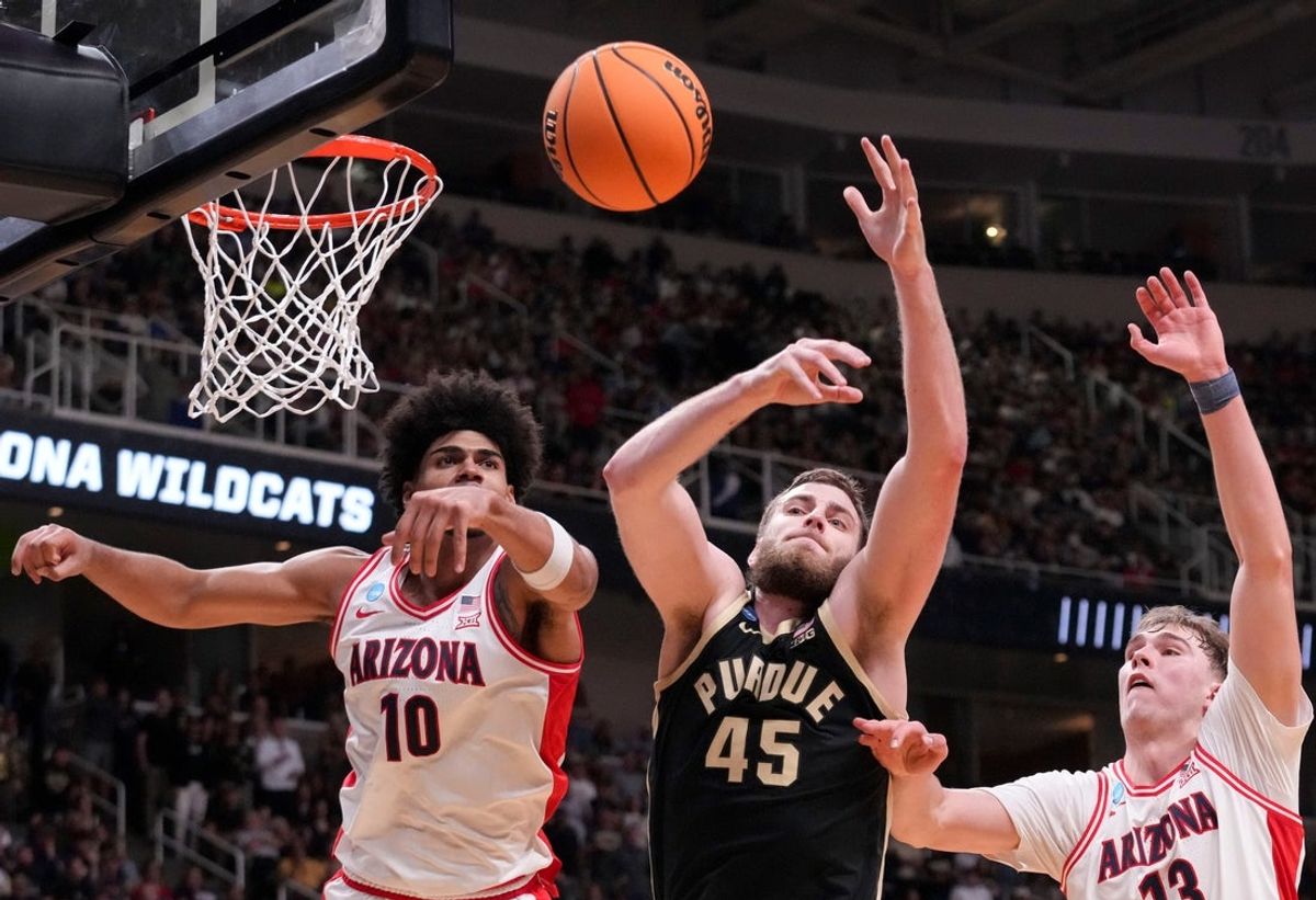 Arizona Wildcats forward Koa Peat (10), Purdue Boilermakers center Oscar Cluff (45) and Arizona Wildcats center Motiejus Krivas (13) battle for control of the ball during a NCAA Tournament game Saturday, March 28, 2026 at SAP Center in San Jose, Calif.