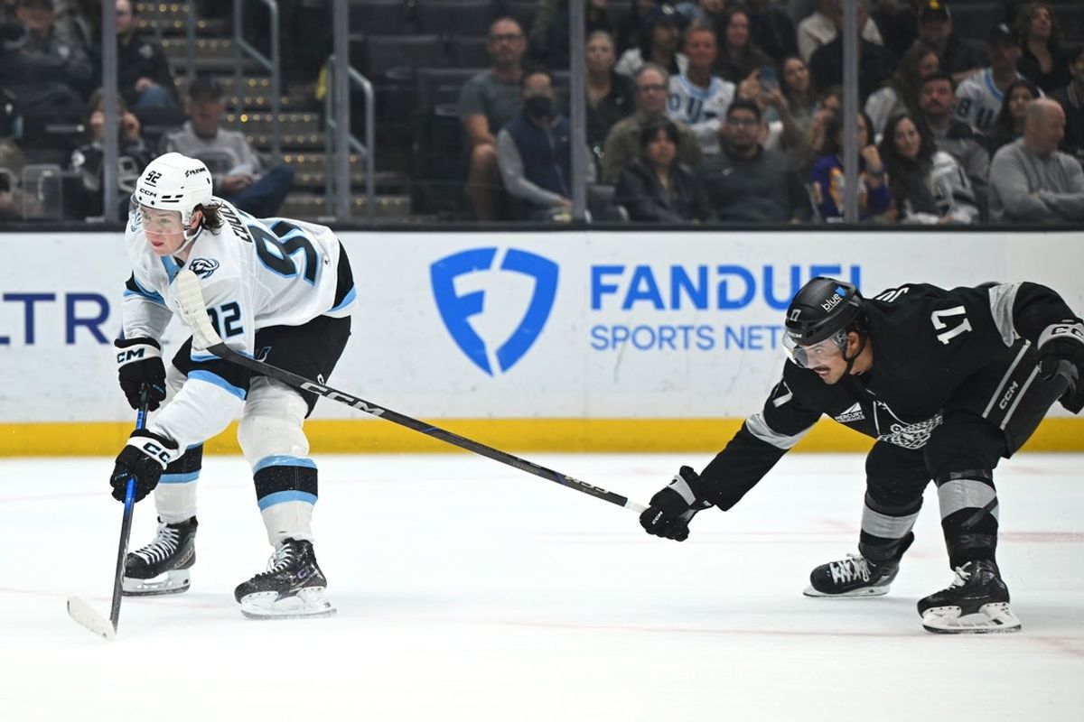 Mar 28, 2026; Los Angeles, California, USA; Utah Mammoth center Logan Cooley (92) and Los Angeles Kings right wing Mathieu Joseph (17) battle for the puck during the first period at Crypto.com Arena. Mandatory Credit: Griffin Hooper-Imagn Images