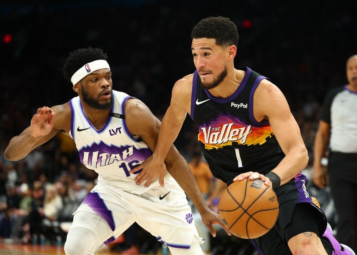 Mar 28, 2026; Phoenix, Arizona, USA; Phoenix Suns guard Devin Booker (1) moves the ball against Utah Jazz guard Elijah Harkless (16) in the second half at Mortgage Matchup Center. Mandatory Credit: Mark J. Rebilas-Imagn Images