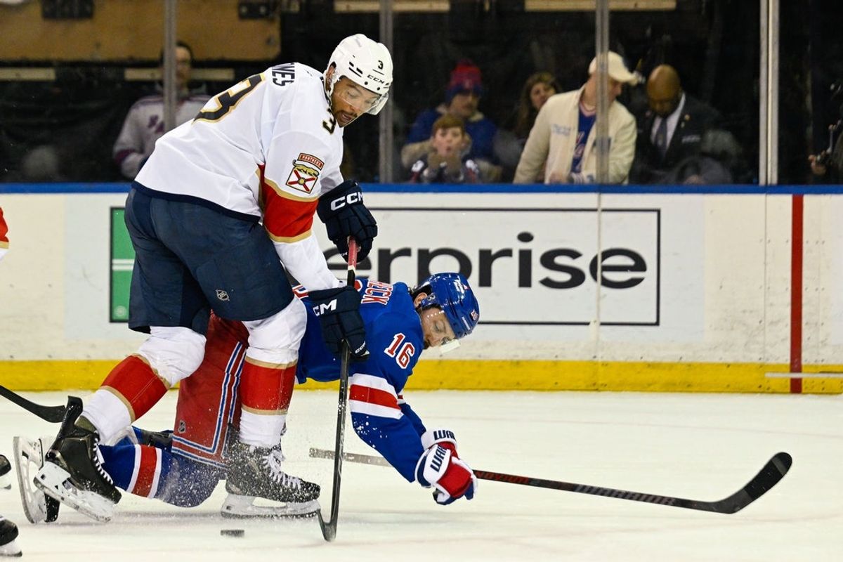 Mar 29, 2026; New York, New York, USA;  Florida Panthers defenseman Seth Jones (3) and New York Rangers center Vincent Trocheck (16) battle for the puck during the first period at Madison Square Garden. Mandatory Credit: Dennis Schneidler-Imagn Images