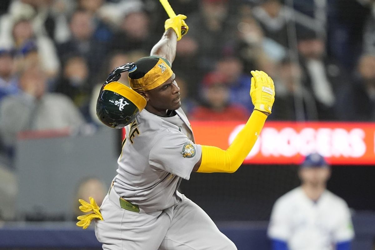 Mar 29, 2026; Toronto, Ontario, CAN; Athletics center fielder Denzel Clarke (1) loses his batting helmet on a swing against the Toronto Blue Jays  during the third inning at Rogers Centre. Mandatory Credit: John E. Sokolowski-Imagn Images