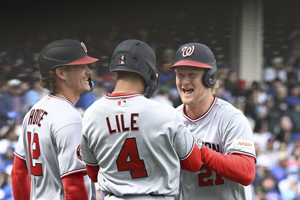 Mar 29, 2026; Chicago, Illinois, USA;  Washington Nationals left fielder Joey Wiemer (21) celebrates with Brady House (12) and right fielder Daylen Lile (4) after they scored on his three-run home run during the first inning against the Chicago Cubs at Wrigley Field. Mandatory Credit: Matt Marton-Imagn Images