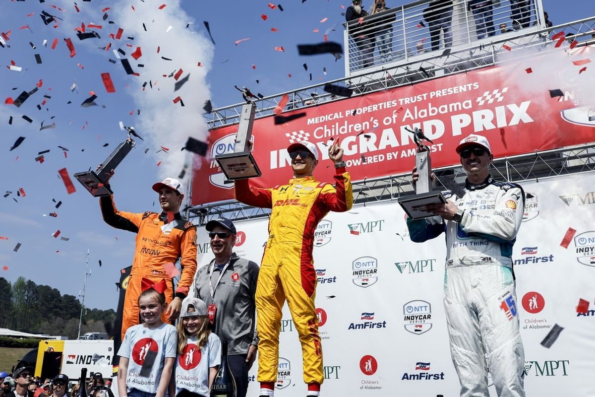 Mar 29, 2026; Birmingham, Alabama, USA;  Graham Rahal (15) of United States, Alex Palou (10), of Spain, and  Christian Lundgaard (7), of Denmark, celebrate at Barber Motorsports Park. Mandatory Credit: Butch Dill-Imagn Images