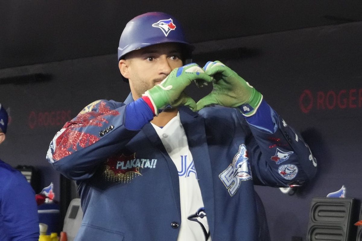 Mar 29, 2026; Toronto, Ontario, CAN; Toronto Blue Jays designated hitter George Springer (4) shows the heart symbol after his solo home run against the Athletics in the first inning at Rogers Centre. Mandatory Credit: John E. Sokolowski-Imagn Images