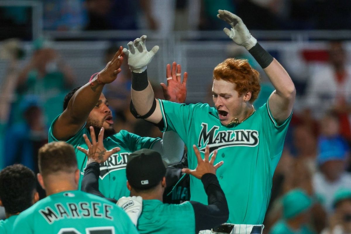 Mar 29, 2026; Miami, Florida, USA; Miami Marlins right fielder Owen Caissie (17) celebrates with teammates after hitting a two-run walk-off home run against the Colorado Rockies during the ninth inning at loanDepot Park. Mandatory Credit: Sam Navarro-Imagn Images
