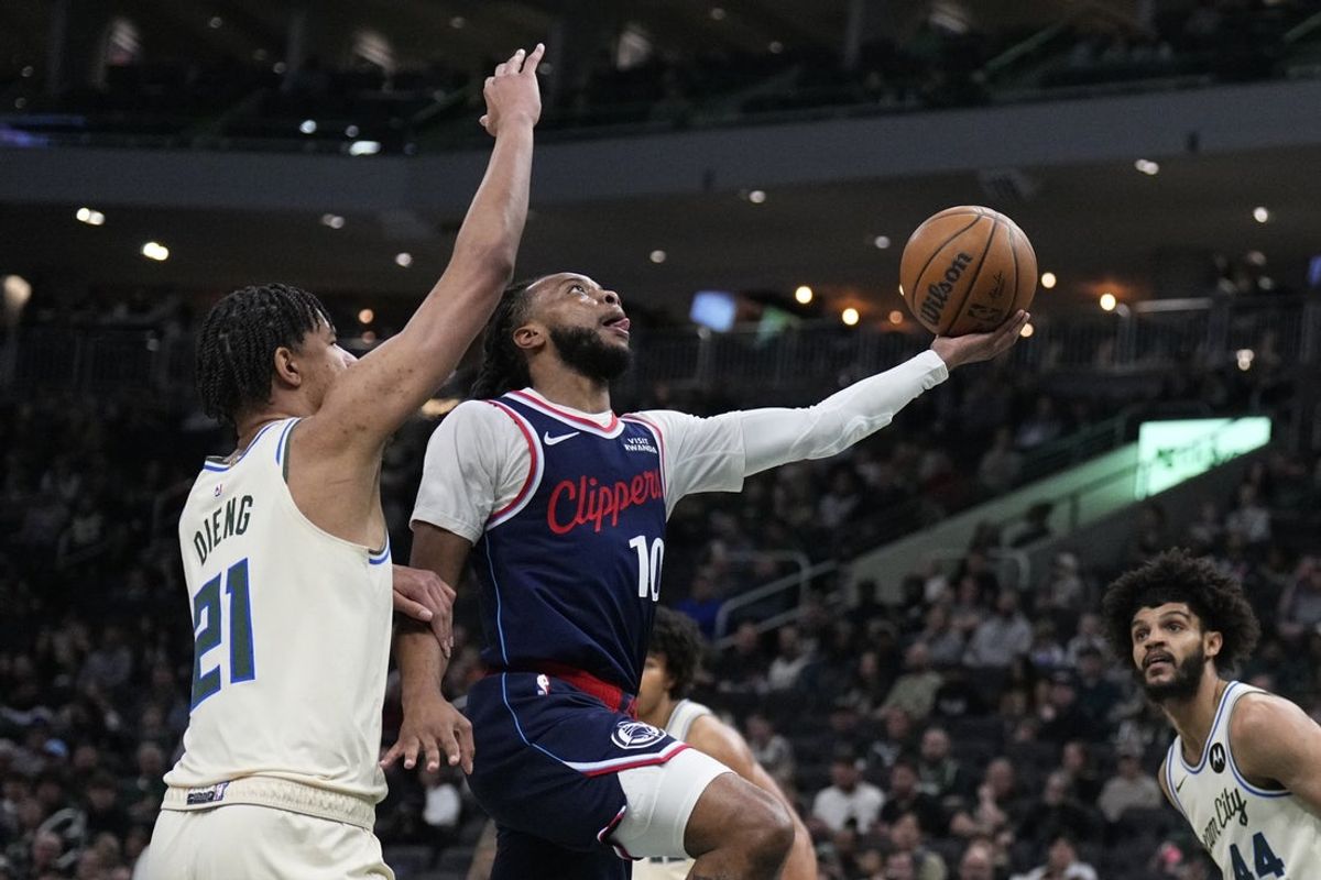 Mar 29, 2026; Milwaukee, Wisconsin, USA; LA Clippers guard Darius Garland (10) drives against Milwaukee Bucks forward Ousmane Dieng (21) in the first half at Fiserv Forum. Mandatory Credit: Michael McLoone-Imagn Images