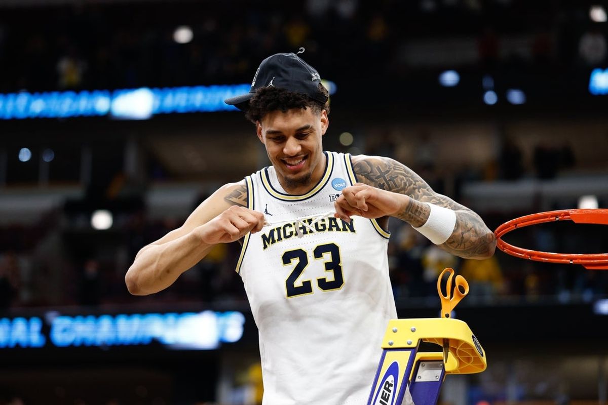 Mar 29, 2026; Chicago, IL, USA; Michigan Wolverines forward Yaxel Lendeborg (23) cuts the net after defeating Tennessee Volunteers in an Elite Eight game of the Midwest Regional of the men's 2026 NCAA Tournament at United Center. Mandatory Credit: Kamil Krzaczynski-Imagn Images