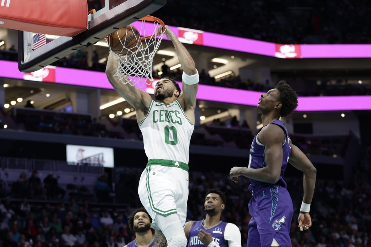 Mar 29, 2026; Charlotte, North Carolina, USA; Boston Celtics forward/guard Jayson Tatum (0) completes a slam dunk as Charlotte Hornets forward Moussa Diabaté (14) looks on during the first quarter at Spectrum Center. Mandatory Credit: Brian Westerholt-Imagn Images