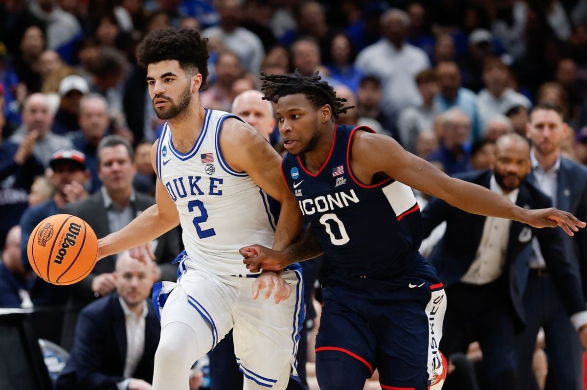 Mar 29, 2026; Washington, DC, USA; Duke Blue Devils guard Cayden Boozer (2) dribbles the ball against UConn Huskies guard Malachi Smith (0) in the second half during an Elite Eight game of the East Regional of the men's 2026 NCAA Tournament at Capital One Arena. Mandatory Credit: Geoff Burke-Imagn Images