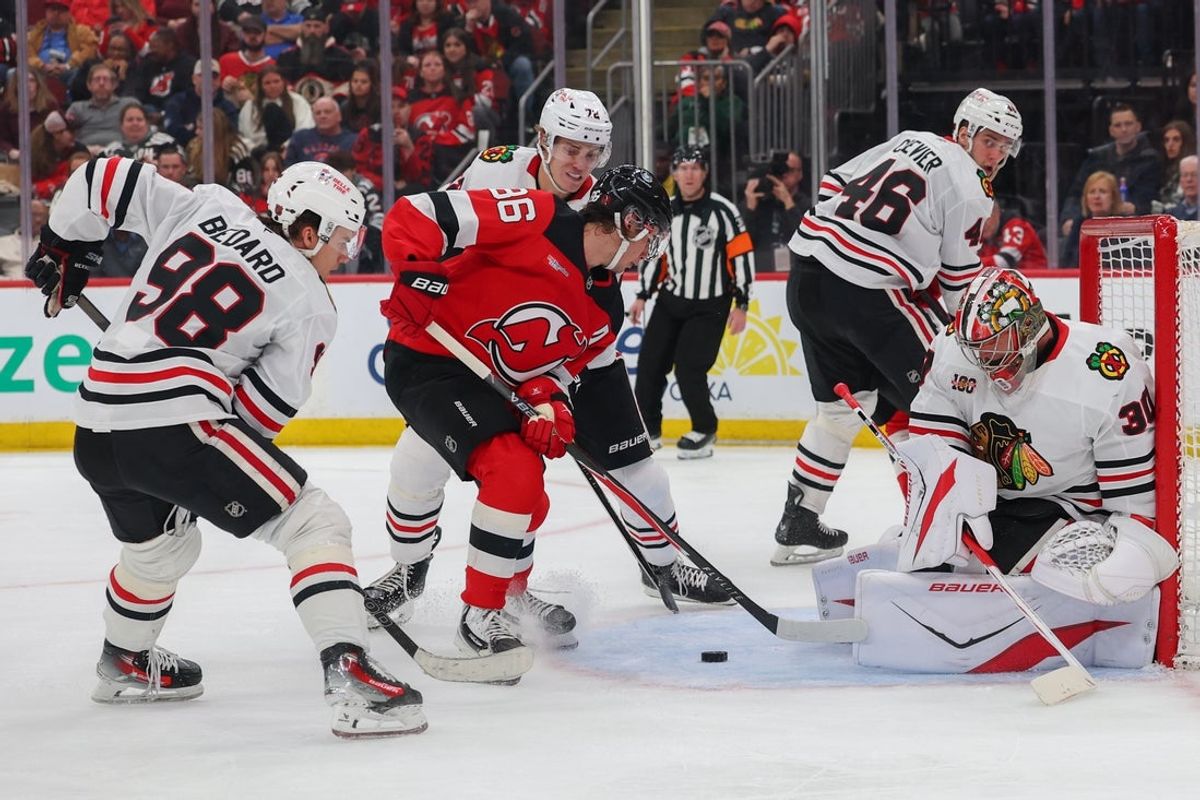 Mar 29, 2026; Newark, New Jersey, USA; Chicago Blackhawks goaltender Spencer Knight (30) makes a save on New Jersey Devils center Jack Hughes (86) during the second period at Prudential Center. Mandatory Credit: Ed Mulholland-Imagn Images