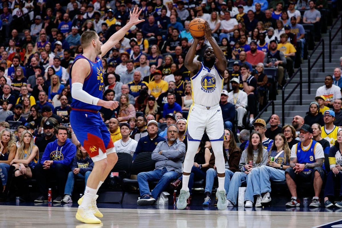 Mar 29, 2026; Denver, Colorado, USA; Golden State Warriors forward Draymond Green (23) attempts a shot as Denver Nuggets center Nikola Jokic (15) guards in the first quarter at Ball Arena. Mandatory Credit: Isaiah J. Downing-Imagn Images