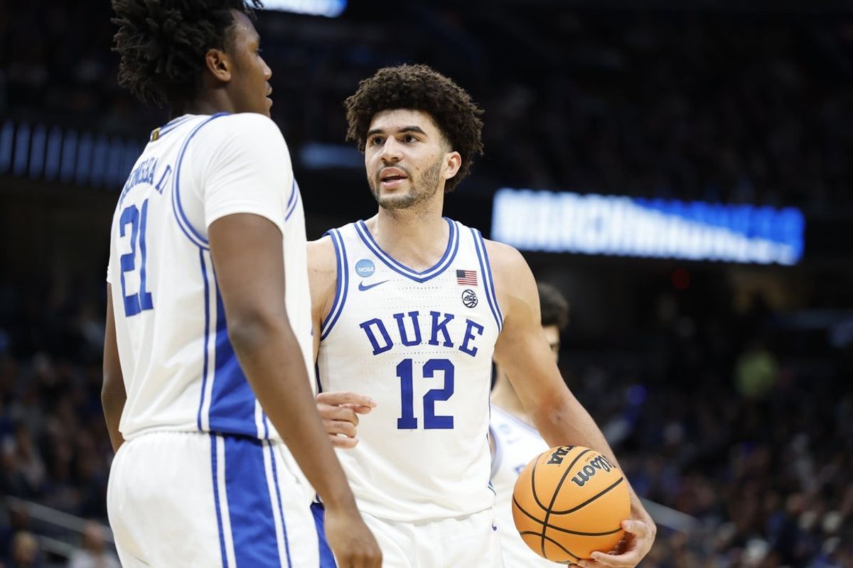 Mar 29, 2026; Washington, DC, USA; Duke Blue Devils forward Cameron Boozer (12) talks to Blue Devils center Patrick Ngongba (21) during a stoppage in play against the UConn Huskies in the second half during an Elite Eight game of the East Regional of the men's 2026 NCAA Tournament at Capital One Arena. Mandatory Credit: Amber Searls-Imagn Images