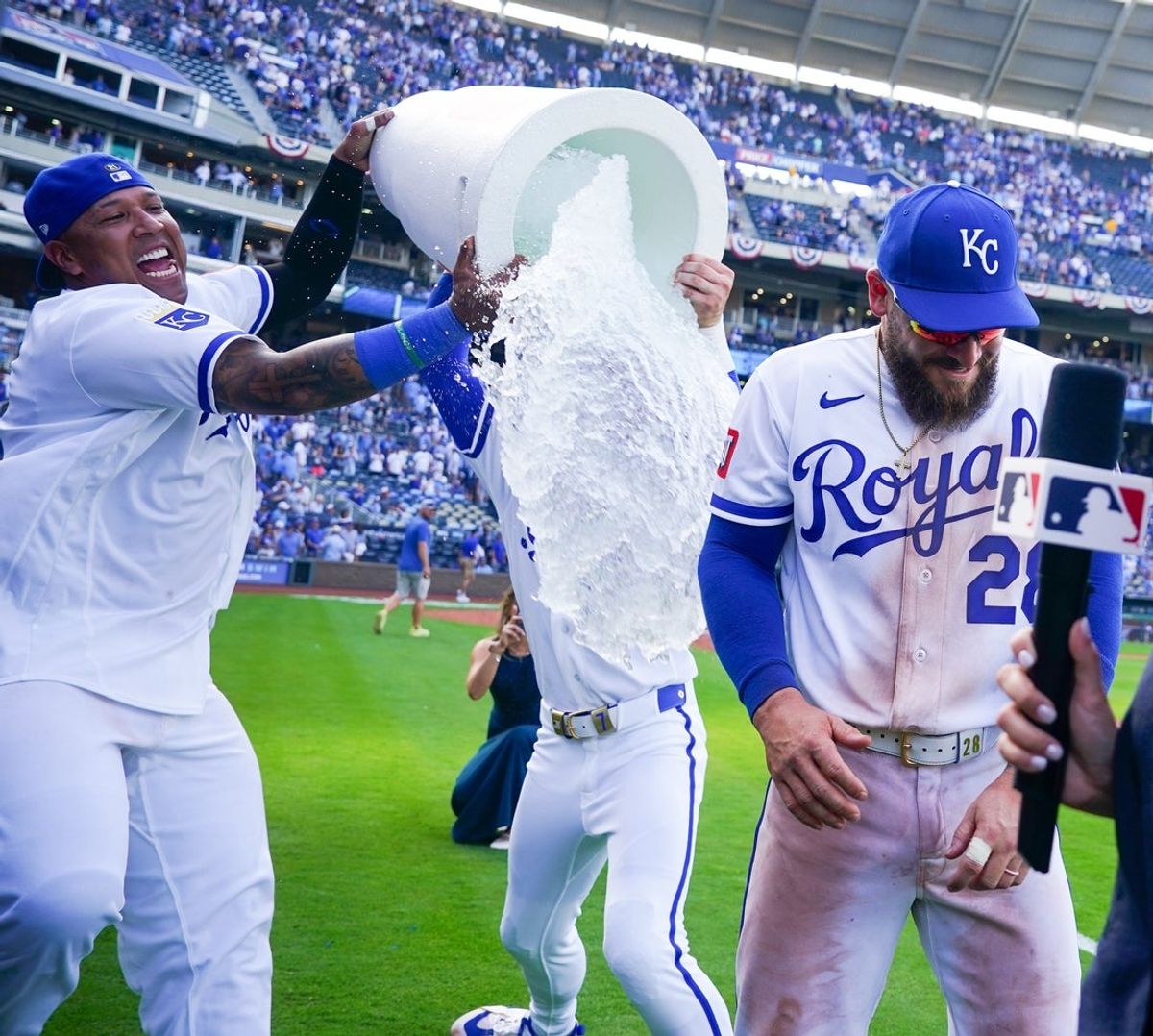 Mar 30, 2026; Kansas City, Missouri, USA; Kansas City Royals center fielder Kyle Isbel (28) is doused by catcher Salvador Perez (13) and shortstop Bobby Witt Jr. (7) after the win over the Minnesota Twins at Kauffman Stadium. Mandatory Credit: Denny Medley-Imagn Images