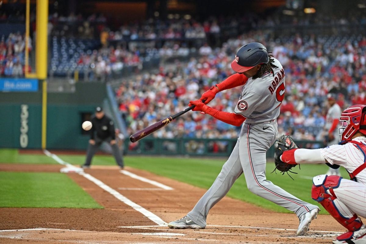 Mar 30, 2026; Philadelphia, Pennsylvania, USA; Washington Nationals shortstop CJ Abrams (5) hits an RBI single during the first inning against the Philadelphia Phillies at Citizens Bank Park. Mandatory Credit: Eric Hartline-Imagn Images