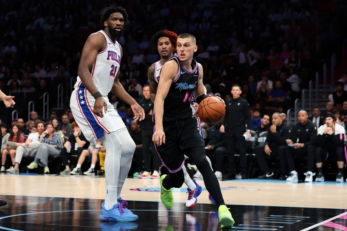 Mar 30, 2026; Miami, Florida, USA; Miami Heat guard Tyler Herro (14) drives to the basket against Philadelphia 76ers center Joel Embiid (21) during the second quarter at Kaseya Center. Mandatory Credit: Sam Navarro-Imagn Images