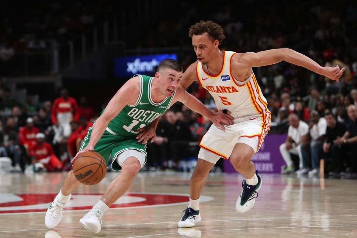 Mar 30, 2026; Atlanta, Georgia, USA; Boston Celtics guard Payton Pritchard (11) dribbles against Atlanta Hawks guard Dyson Daniels (5) in the first half at State Farm Arena. Mandatory Credit: Mady Mertens-Imagn Images