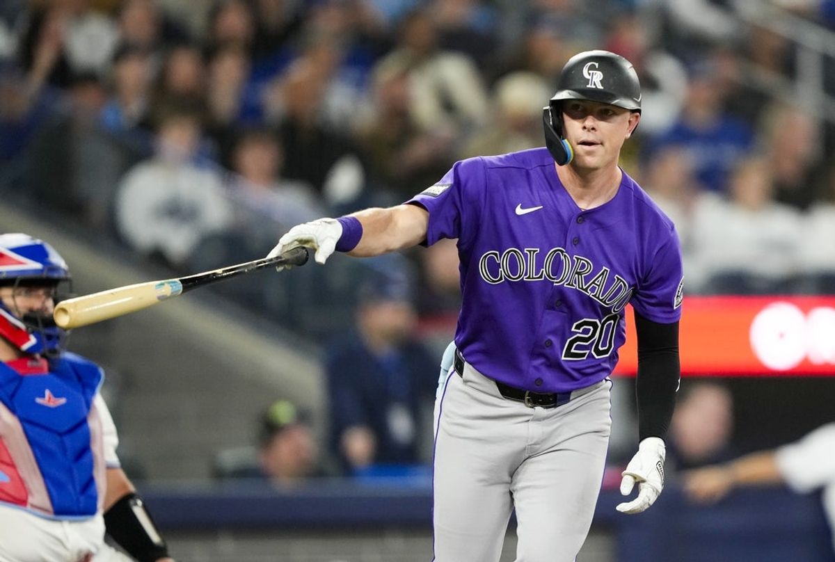 Mar 30, 2026; Toronto, Ontario, CAN;  Colorado Rockies Troy Johnston (20) hits a home rum against the Toronto Blue Jays during the sixth inning at Rogers Centre. Mandatory Credit: Kevin Sousa-Imagn Images