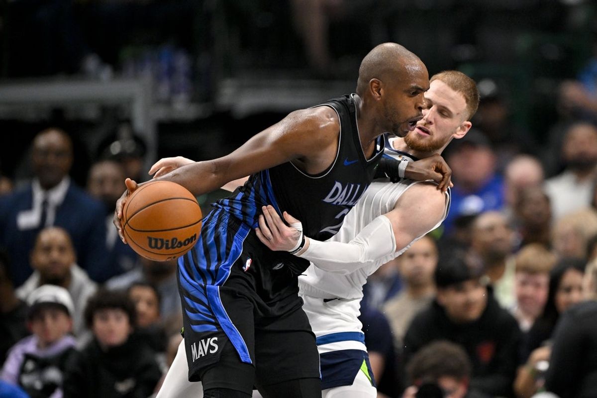 Mar 30, 2026; Dallas, Texas, USA; Dallas Mavericks forward Khris Middleton (20) looks to move the ball past Minnesota Timberwolves guard Donte DiVincenzo (0) during the second quarter at the American Airlines Center. Mandatory Credit: Jerome Miron-Imagn Images