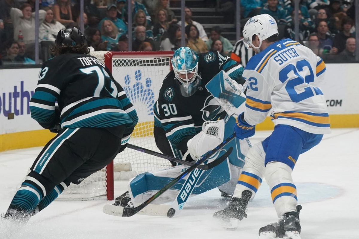 Mar 30, 2026; San Jose, California, USA;  San Jose Sharks goaltender Yaroslav Askarov (30) blocks a shot by St. Louis Blues center Pius Suter (22) as center Tyler Toffoli (73) assists on defense during the first period at SAP Center at San Jose. Mandatory Credit: David Gonzales-Imagn Images