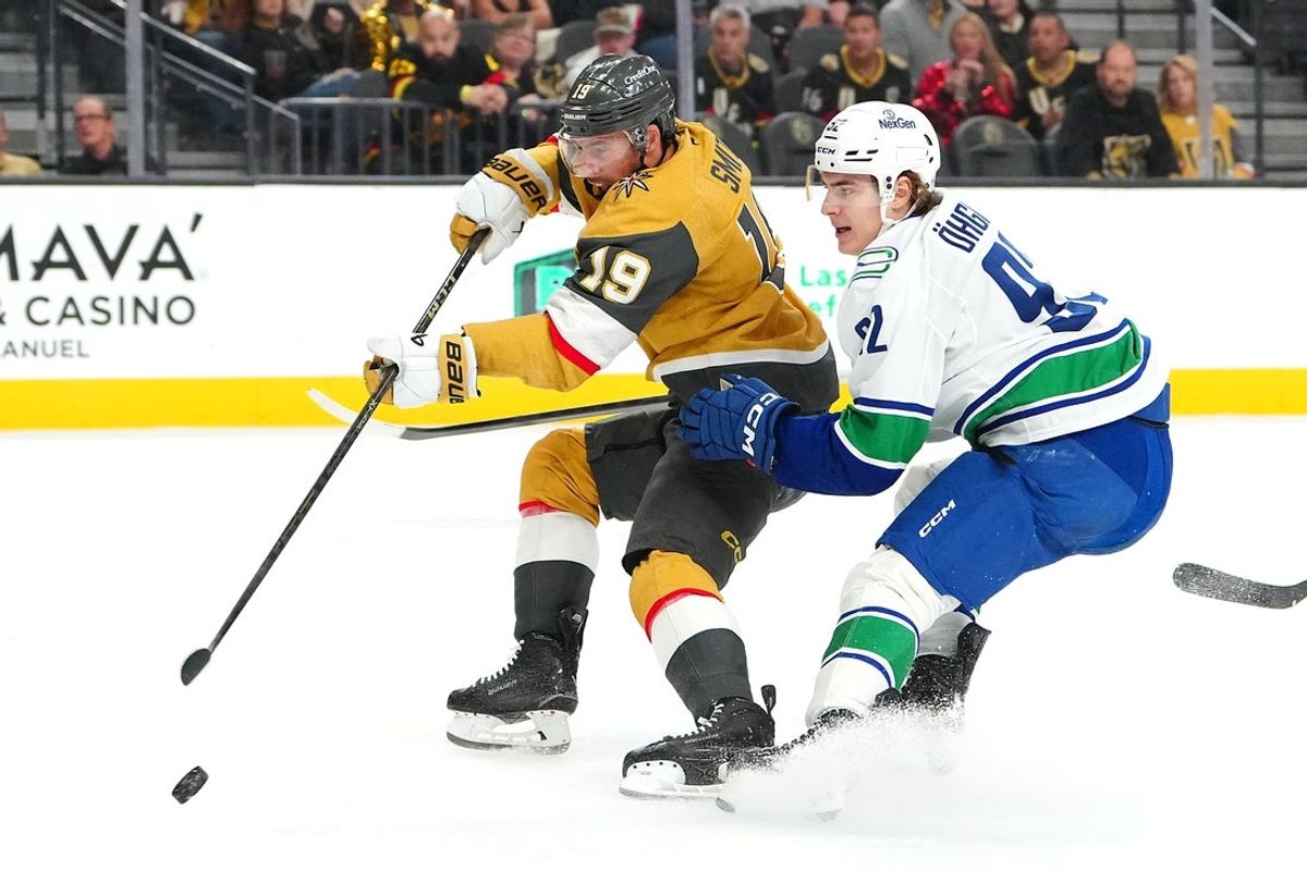 Mar 30, 2026; Las Vegas, Nevada, USA; Vegas Golden Knights right wing Reilly Smith (19) shoots ahead of Vancouver Canucks left wing Liam Ohgren (92) during the first period at T-Mobile Arena. Mandatory Credit: Stephen R. Sylvanie-Imagn Images