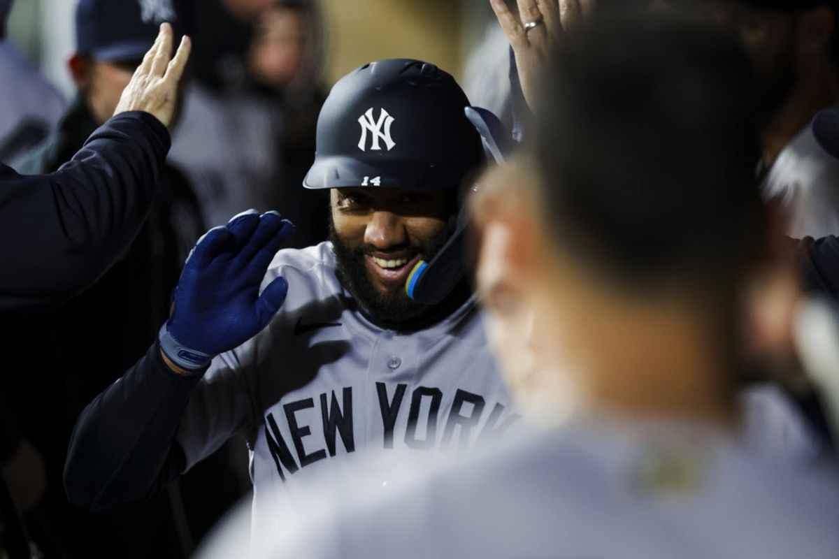 Mar 30, 2026; Seattle, Washington, USA; New York Yankees pinch hitter Amed Rosario (14) high-fives teammates in the dugout after hitting an RBI-sacrifice fly against the Seattle Mariners during the seventh inning at T-Mobile Park. Mandatory Credit: Joe Nicholson-Imagn Images