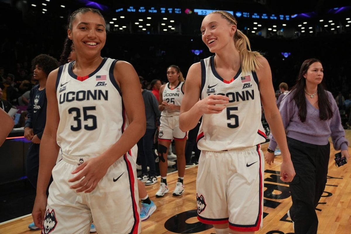 Dec 7, 2024; Brooklyn, New York, USA; Connecticut Huskies guard Azzi Fudd (35) and Connecticut Huskies guard Paige Bueckers (5) celebrate after the game against the Louisville Cardinals at Barclays Center.