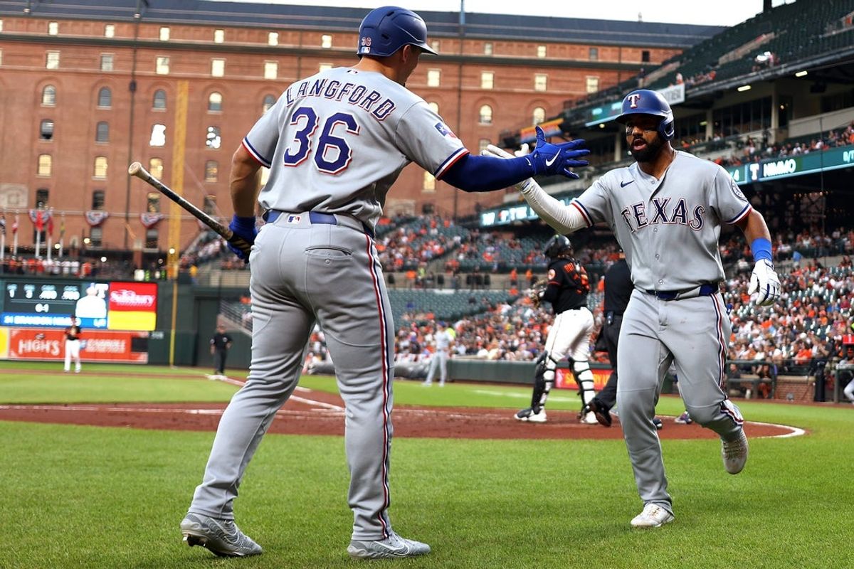 Mar 31, 2026; Baltimore, Maryland, USA; Texas Rangers shortstop Ezequiel Duran (20) celebrates with Texas Rangers left fielder Wyatt Langford (36) after hitting a home run during the third inning against the Baltimore Orioles at Oriole Park at Camden Yards. Mandatory Credit: Daniel Kucin Jr.-Imagn Images