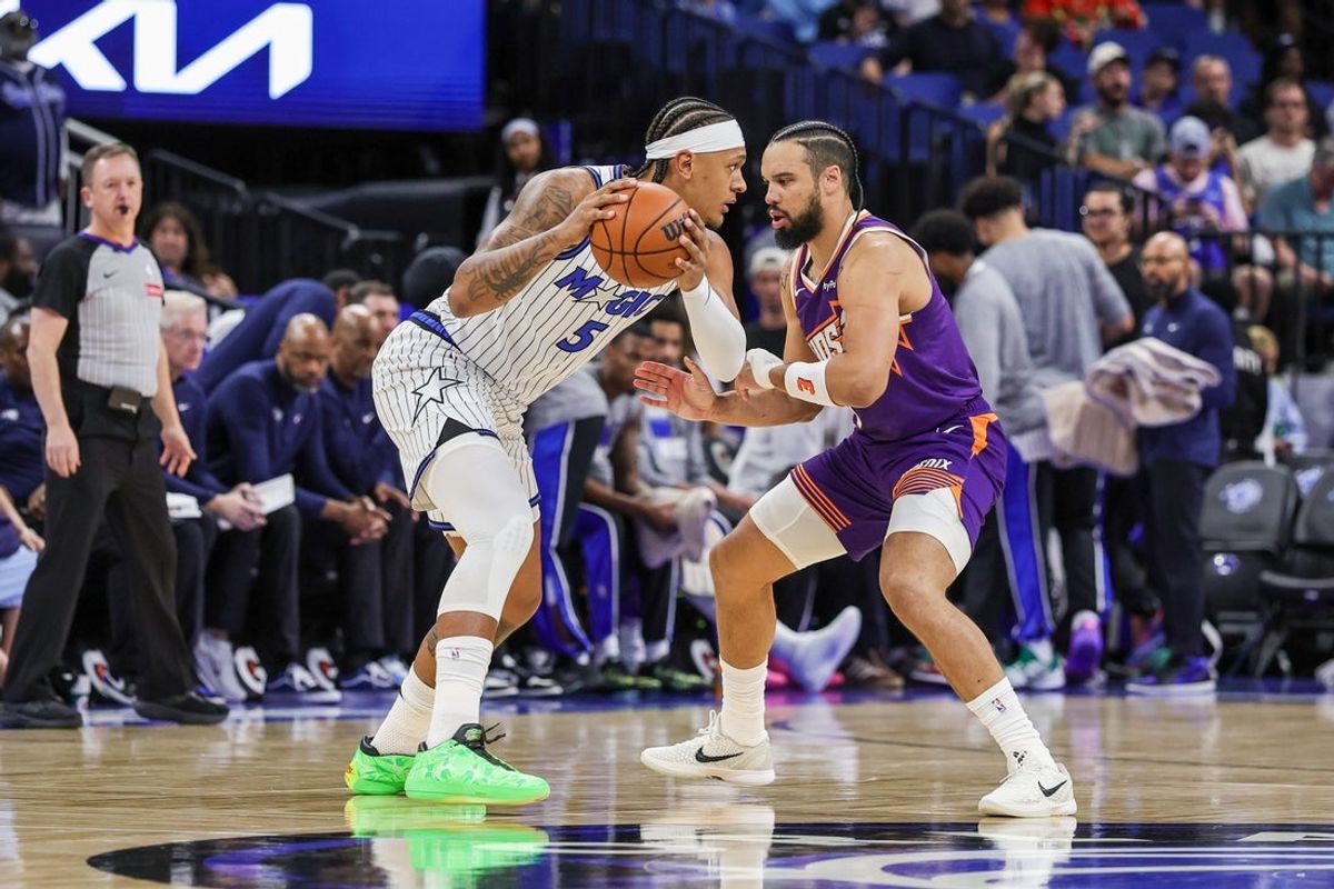 Mar 31, 2026; Orlando, Florida, USA; Orlando Magic forward Paolo Banchero (5) handles the ball in front of Phoenix Suns forward Dillon Brooks (3) during the first quarter at Kia Center. Mandatory Credit: Mike Watters-Imagn Images