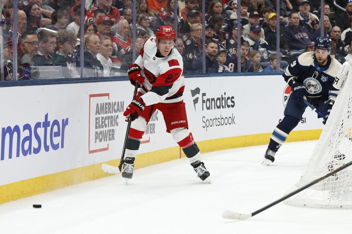 Mar 31, 2026; Columbus, Ohio, USA; Carolina Hurricanes left wing Nikolaj Ehlers (27) passes the puck as Columbus Blue Jackets defenseman Ivan Provorov (9) defends during the first period at Nationwide Arena. Mandatory Credit: Russell LaBounty-Imagn Images
