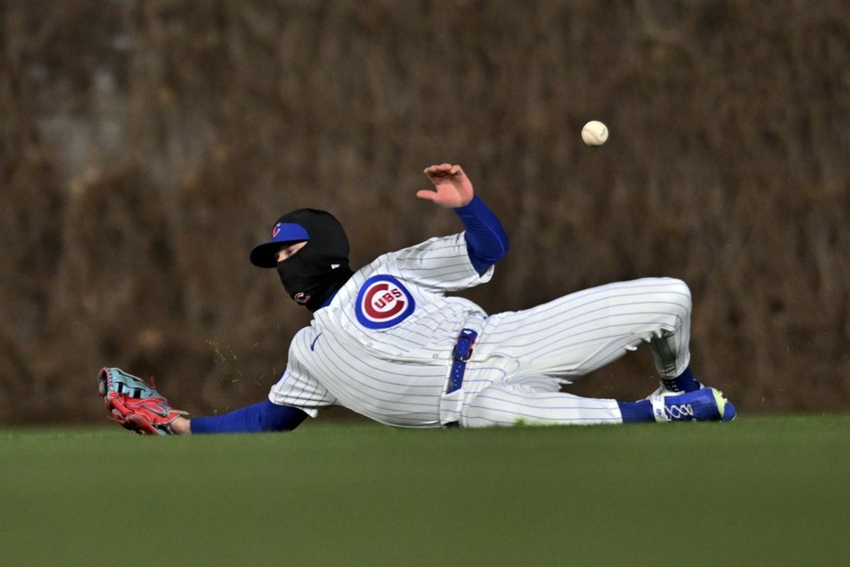 Mar 31, 2026; Chicago, Illinois, USA; Chicago Cubs center fielder Pete Crow-Armstrong (4) attempts to catch Los Angeles Angels third baseman Jeimer Candelario (not pictured) double during the sixth inning at Wrigley Field. Mandatory Credit: Patrick Gorski-Imagn Images