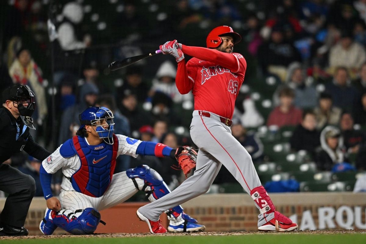 Mar 31, 2026; Chicago, Illinois, USA; Los Angeles Angels third baseman Jeimer Candelario (46) hits a double against the Chicago Cubs during the sixth inning at Wrigley Field. Mandatory Credit: Patrick Gorski-Imagn Images