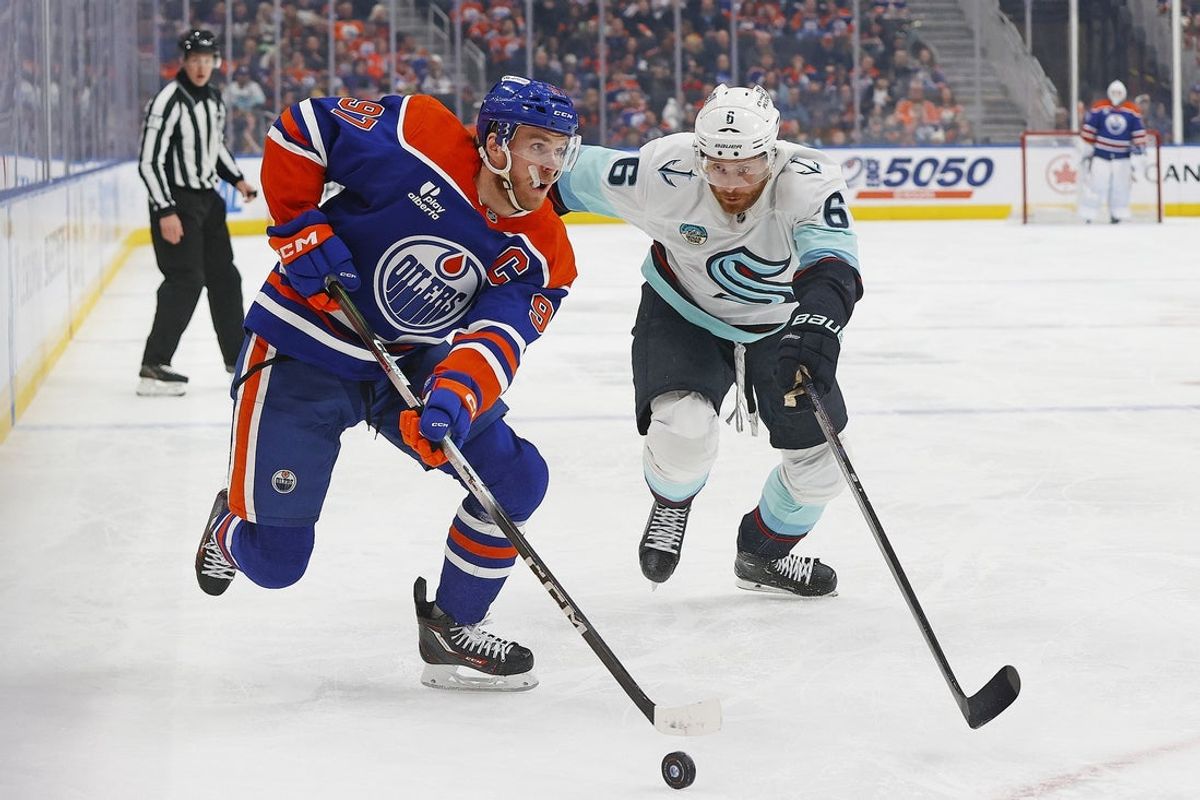 Mar 31, 2026; Edmonton, Alberta, CAN; Edmonton Oilers forward Connor McDavid (97) looks to make a play in front of Seattle Kraken defensemen Adam Larsson (6) during the first period at Rogers Place. Mandatory Credit: Perry Nelson-Imagn Images