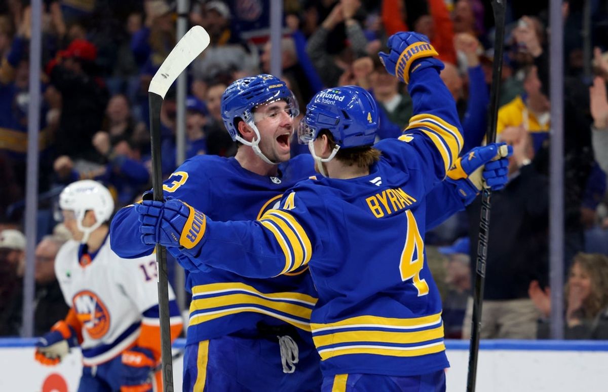 Mar 31, 2026; Buffalo, New York, USA;  Buffalo Sabres defenseman Bowen Byram (4) celebrates his open net goal with defenseman Mattias Samuelsson (23) during the third period against the New York Islanders at KeyBank Center. Mandatory Credit: Timothy T. Ludwig-Imagn Images