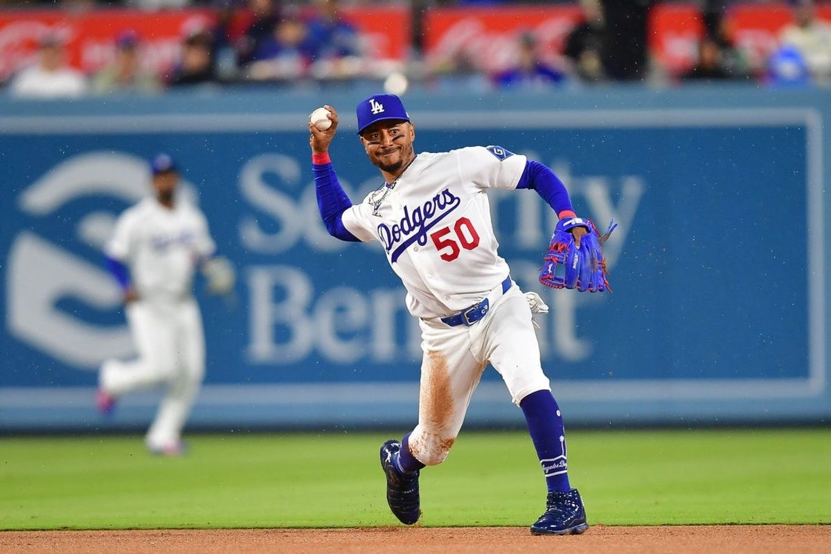 Mar 31, 2026; Los Angeles, California, USA; Los Angeles Dodgers shortstop Mookie Betts (50) throws to first for the out against Cleveland Guardians shortstop Gabriel Arias (13) during the fifth inning at Dodger Stadium. Mandatory Credit: Gary A. Vasquez-Imagn Images