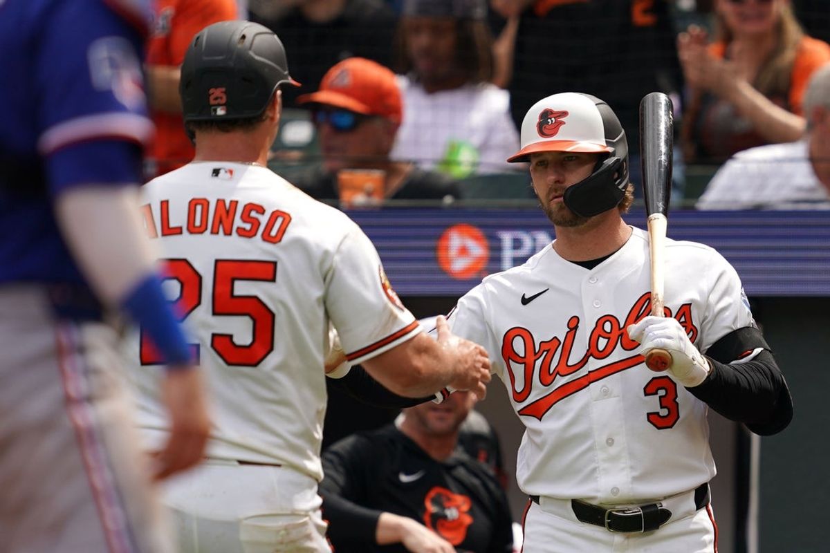 Apr 1, 2026; Baltimore, Maryland, USA; Baltimore Orioles first baseman Pete Alonso (25) greeted by outfielder Taylor Ward (3) after scoring a run during the third inning against the Texas Rangers at Oriole Park at Camden Yards. Mandatory Credit: Mitch Stringer-Imagn Images