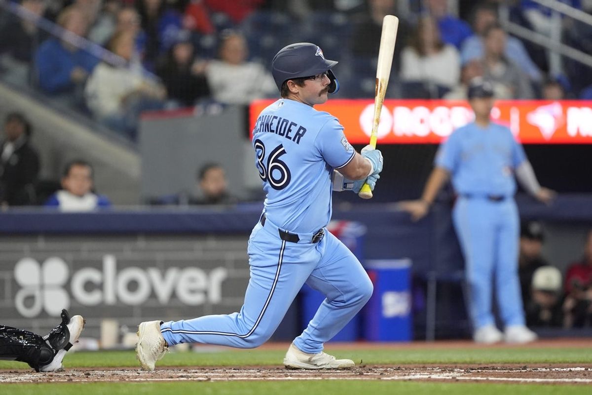 Apr 1, 2026; Toronto, Ontario, CAN; Toronto Blue Jays left fielder Davis Schneider (36) hits a one run double against the Colorado Rockies during the third inning at Rogers Centre. Mandatory Credit: John E. Sokolowski-Imagn Images