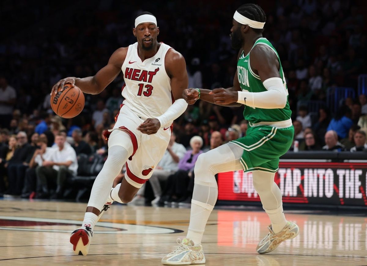 Apr 1, 2026; Miami, Florida, USA; Miami Heat center Bam Adebayo (13) drives to the basket against Boston Celtics center Neemias Queta (88) during the first quarter at Kaseya Center. Mandatory Credit: Sam Navarro-Imagn Images